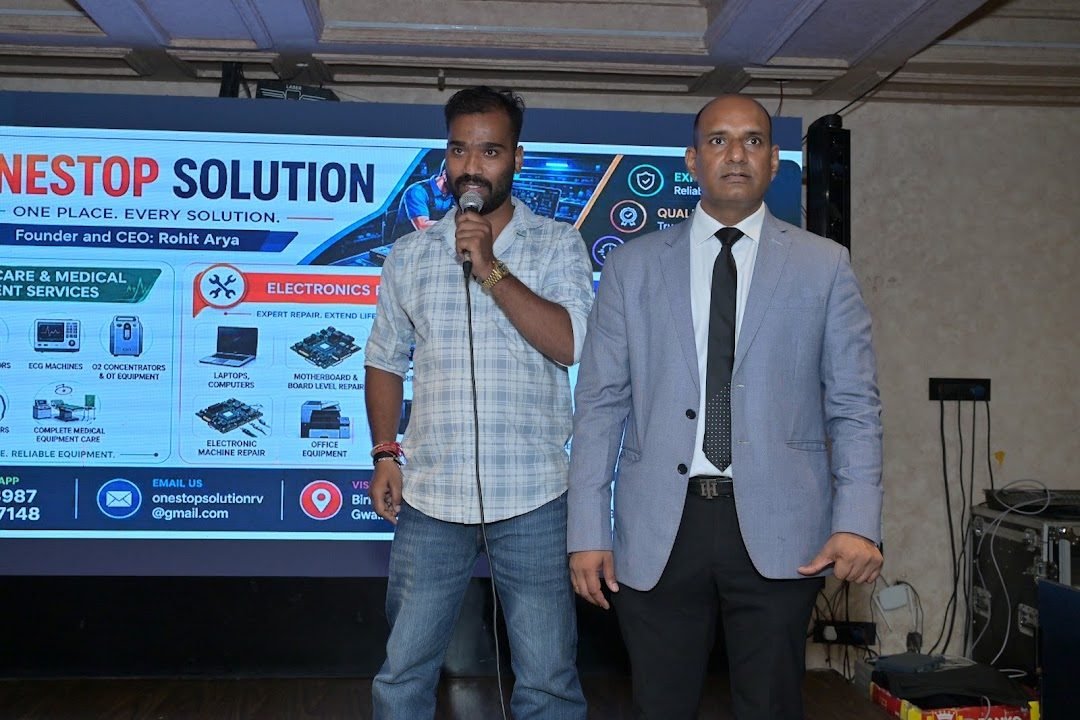Presentation at an event in front of a OneStop Solution display naming Rohit Arya as Founder and CEO